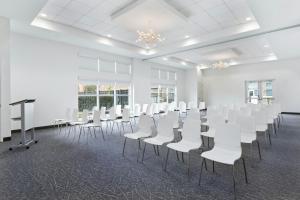 a room with rows of white chairs and a podium at Element by Marriott Houston Katy in Katy +50 photos