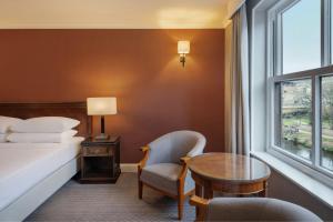 a hotel room with a bed and a table and a window at Delta Hotels by Marriott Durham Royal County in Durham +55 photos