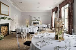 a dining room with white tables and chairs at Delta Hotels by Marriott Durham Royal County in Durham