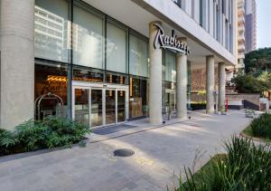 a store front of a building with a sign on it at Radisson Pinheiros in São Paulo +49 photos