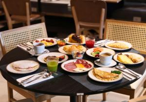 a black table with plates of food on it at Radisson Pinheiros in São Paulo