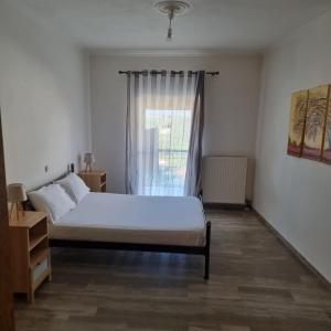 a bedroom with a bed and a window at Sea View apartment in Gythio