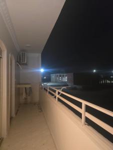 a hallway of a building at night with a fence at النزهه in Quseir