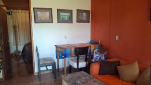 a living room with a table and a couch at Cabaña con chimenea Paipa in Paipa