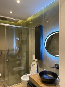 a bathroom with a toilet and a glass shower at Golden Villa in Theth +45 photos