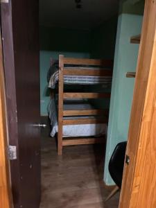 a small room with a bunk bed in a room at Cabañas rio fuy Tinaja in Puyehue