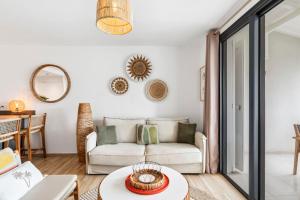 a living room with a couch and a table at Alamanda 114 Oceanview 2BR Steps from Orient Bay in Orient Bay