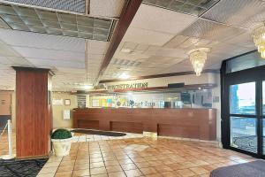 a lobby of a restaurant with a waiting room at Airport Inn Memphis Near Graceland By Hotel O in Memphis