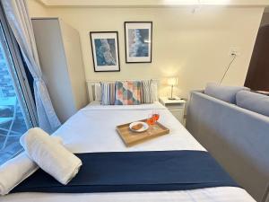 a bedroom with a bed with a tray of food on it at Nova Residences Viman Studios in Pune