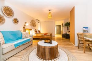 a living room with a couch and a table at Studio 6 Alamanda Resort Orient Bay in Orient Bay