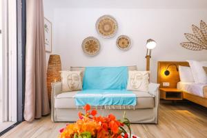 a living room with a couch and a bed at Studio 6 Alamanda Resort Orient Bay in Orient Bay