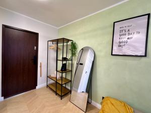 a mirror leaning against a wall next to a room at Studio Jurasz I in Bydgoszcz