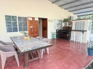 a dining room with a table and chairs at BREEZE Hostal Boca Chica in Boca Chica
