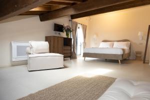 a bedroom with a bed and a chair at Casa Gabri Boutique B&B Tuscan Villa retreat in Massa