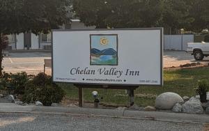 a sign for the chatham valley inn in a parking lot at Chelan Valley Inn in Manson