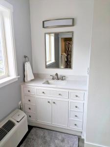 a white bathroom with a sink and a mirror at Chelan Valley Inn in Manson