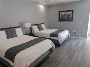 a hotel room with two beds and a picture on the wall at Chelan Valley Inn in Manson