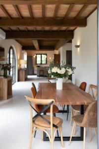 a dining room with a wooden table and chairs at Casa Gabri Boutique B&B Tuscan Villa retreat in Massa