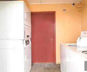 a red door in a kitchen with a refrigerator at Vienna Travel Inn in Vienna