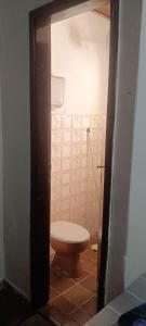 a small bathroom with a toilet in a room at Pousada Popular in Barreiras