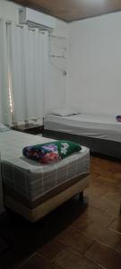 two beds sitting in a room with a mattress at Pousada Popular in Barreiras