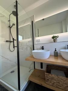 a bathroom with two sinks and a shower at Hygge in Neumünster