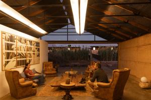 a group of people sitting in chairs on a patio at Fauna Atacama in San Pedro de Atacama +37 photos
