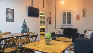 a living room with a christmas tree and a table at Vintagyn Hostel in Goiânia