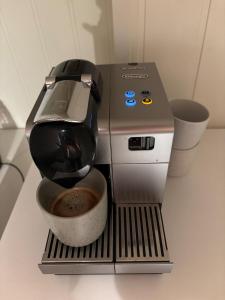 a coffee machine sitting on a counter with a bowl at Loftsrom in Drammen