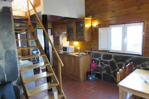a kitchen with a spiral staircase in a cabin at Lusitaurus in Montoito