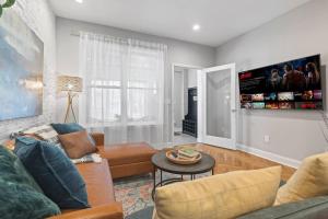 a living room with a couch and a table at Spacious 3BR Near Art Museum Patio Gameroom in Philadelphia