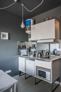 a kitchen with white cabinets and a counter top at Fuerteventura in Loft in Gran Tarajal