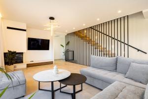 a living room with a couch and a table at FOGE luxury villa Agios Onoufrios in Chania