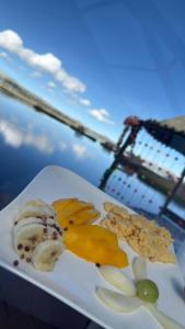 a plate of food with fruit and nuts on a table at Titicaca Magical Lodge Peru in Puno +32 photos
