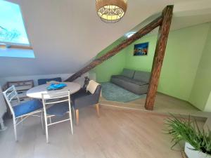 a living room with a couch and a table at KissApartman in Kőszeg +5 photos