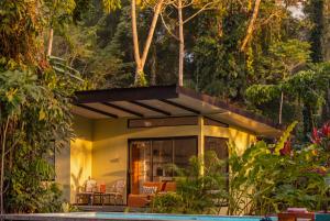 a house in the middle of a garden at Exōtico Beach Hotel in Puerto Viejo