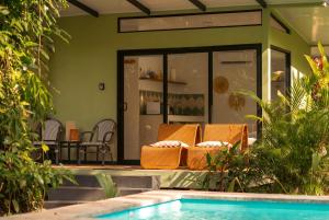 a house with a swimming pool and a patio at Exōtico Beach Hotel in Puerto Viejo