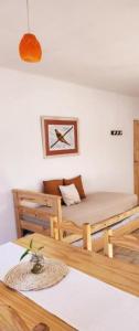 a room with a bed and a table at PISO UNO - Gran Living Comedor y Habitación - PET FRIENDLY - AUTO CHECK IN 24 HS - Para 4 personas - No alquilamos a Bahienses por el momento in Bahía Blanca