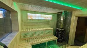 a sauna with a green lighting in a room at Love's Mount Resort in Slavske +87 photos