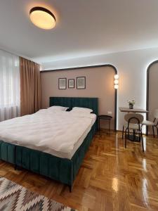 a bedroom with a large bed and a table at 2001 Central Stay in Peje