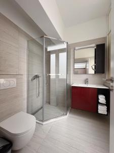 a bathroom with a shower and a toilet and a sink at 2001 Central Stay in Peje +30 photos