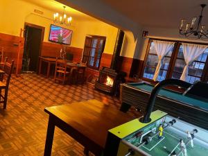 a living room with a pool table and a fireplace at Posada Calera in Valle De Villaverde