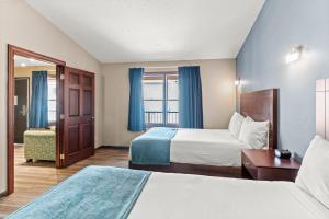a hotel room with two beds and a window at Edgewater Hotel and Suites in Put-in-Bay