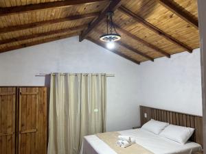 a bedroom with a bed with a teddy bear on it at Mini Fazenda Park in Santana do Livramento +30 photos