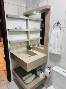 a bathroom with a sink and a mirror at Casa de campo com cachoeira no quintal in Gaspar +85 photos