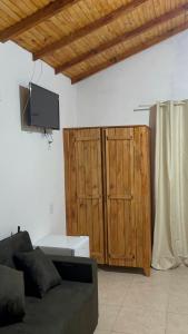 a living room with a couch and a tv at Mini Fazenda Park in Santana do Livramento