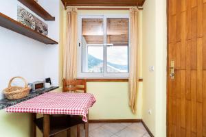 a kitchen with a table and a window at Apartment Bezerusa in Igrane