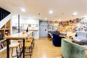 a room with a table and chairs and a library at JGSTAY - Times Square in New York +21 photos