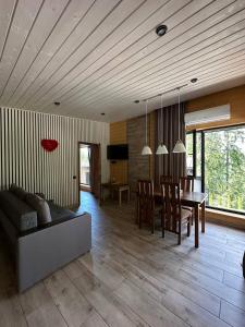 a living room with a table and a dining room at Love's Mount Resort in Slavske