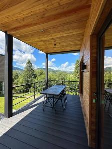 a wooden deck with a picnic table on it at Love's Mount Resort in Slavske